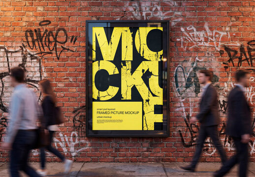 Outdoor poster mockup on brick wall with graffiti and people walking