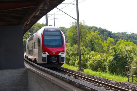 SBB CFF FFS passenger train at railway station of Swiss village of Glattfelden on a sunny late summer day. Photo taken September 7th, 2025, Zurich Glattfelden, Switzerland.