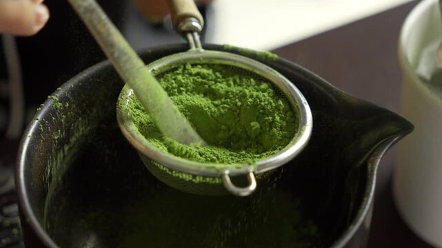 Macro Close Up of Sift Green Ceremonial Matcha Powder Through Metal Sieve for Traditional Japanese Tea Preparation