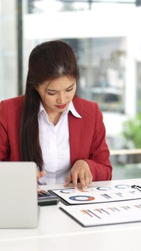 Business woman working in office checking documents.Accounting manager executive or lawyer using laptop reading paper file financial report, tax invoice.