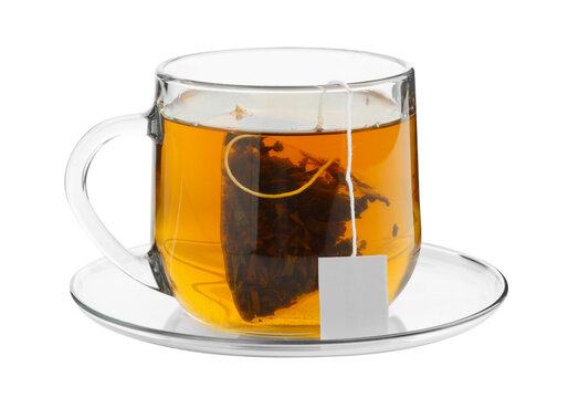Clear glass cup of hot tea with tea bag on saucer, herbal tea isolated on transparent background PNG