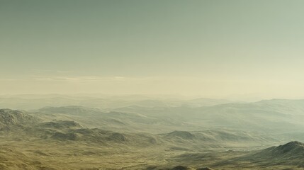 Fototapeta premium Extensive mountain landscape presenting rolling hills and deep valleys covered in mist, creating a sense of distance and serene natural beauty during a hazy sunrise