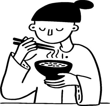 Person eating noodles with chopsticks at tabletop setting