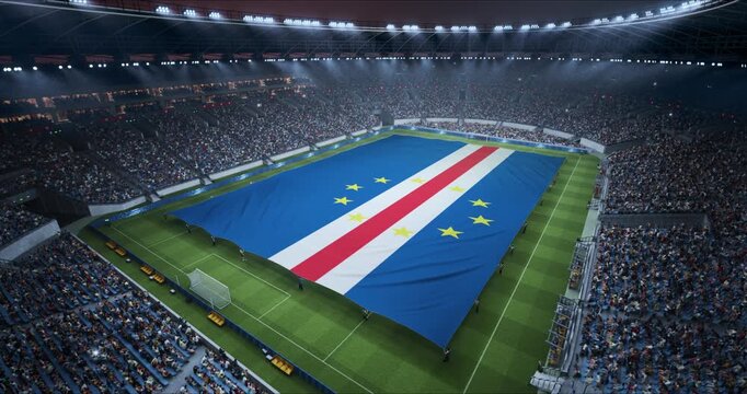Professional Stadium With Soccer Game Championship With Flag of Cape Verde Spread Across Pitch Before Football Match Start. Cheering Crowds of Fans at Arena Anthem Ceremony. Aerial Static Wide Shot