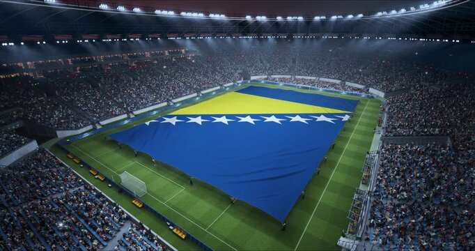 Professional Stadium With Soccer Game Championship With Flag of Bosnia and Herzegovina Spread Across Pitch Before Football Match Start. Cheering Crowds of Fans at the Arena. Aerial Static Wide Angle