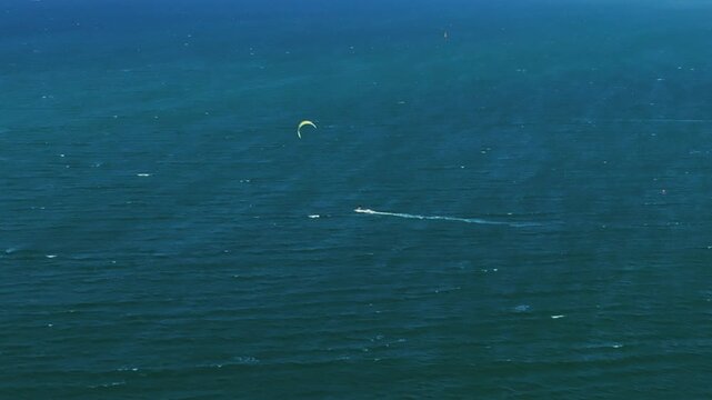 Aerial 4K parasailing adventure over turquoise ocean in Nha Trang Vietnam
the thrill of extreme water sports, the vibrant colors of the parachute, and the white wake of the boat against the blue sea