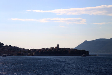 Naklejka premium Small town Korcula, on island Korcula, Croatia, illuminated by back light. Summer travel destination.