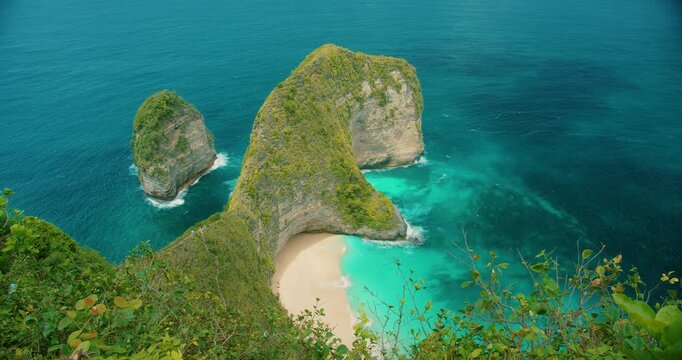 Crystal clear turquoise water at Kelingking Beach cove in Nusa Penida Bali
