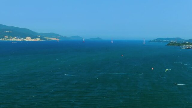 Aerial 4K parasailing adventure over turquoise ocean in Nha Trang Vietnam
the thrill of extreme water sports, the vibrant colors of the parachute, and the white wake of the boat against the blue sea