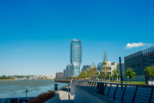 View of the Belgrade Waterfront featuring the Kula Belgrade skyscraper and the Sava river promenade under a clear blue sky in Belgrade, City of Belgrade, Serbia.