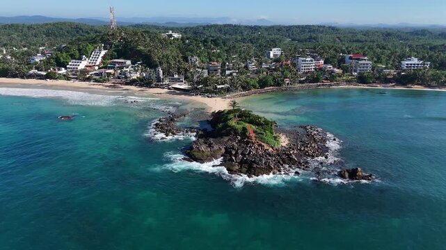 Aerial view of Parrot Rock and the sandspit connecting it to the main beach. Mirissa, Sri Lanka