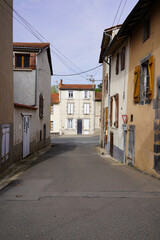 Fototapeta premium Narrow street in French village with traditional houses and quiet residential view