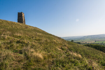 Fototapeta premium Historic St Michaels Tower on Glastonbury Tor Hill under Clear Blue Sky 