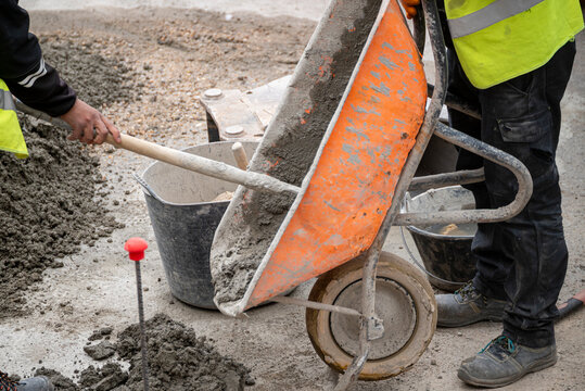 Two men working with concrete on a building site The Concept of collaboration