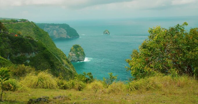 Steep limestone cliffs meet the blue Indian Ocean at Nusa Penida Bali island
