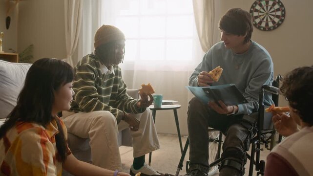 Handheld shot of young man in wheelchair telling about his moto accident and showing his leg z-ray