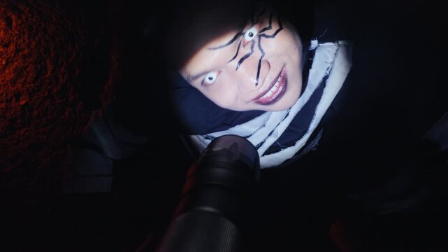 Menacing Man with Spider Face Paint Crawling Towards Camera