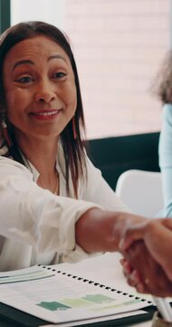 Woman, handshake and smile with success at office for applause, goals or thanks at insurance company. People, shaking hands and happy for deal, feedback and congratulations at risk management agency