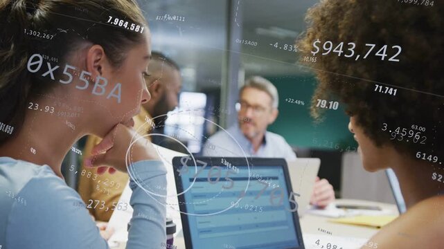 Two women tapping tablet and pointing at laptop reviewing finance and starting AR HUD graphs