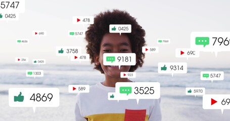 Fototapeta premium Smiling child standing at beach, in white tee, surrounded by notification icons and sea