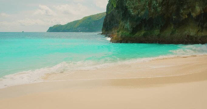 Beautiful coastline view of turquoise ocean waves and sandy beach in Nusa Penida Bali