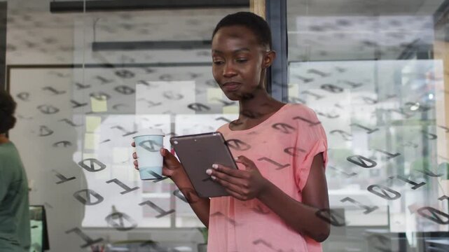 Lead woman sipping cup then lowering and scrolling tablet, checking business behind binary glass