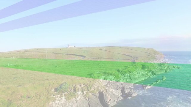 Coastal headland panning right after frame start, colored bands sweeping to reveal ridge building