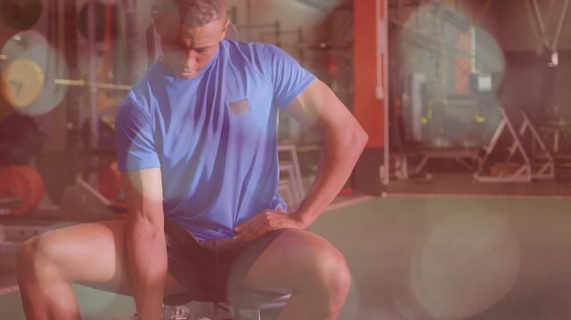 Man sitting on adjustable bench gripping dumbbell, curling in gym, overlays guiding technique