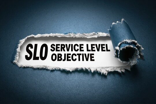 SLO Service Level Objective acronym under torn paper