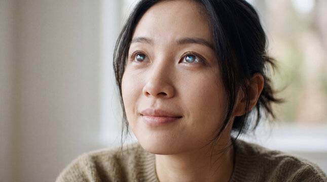 A portrait of a thoughtful woman with a soft gaze, capturing a moment of contemplation and serenity. 