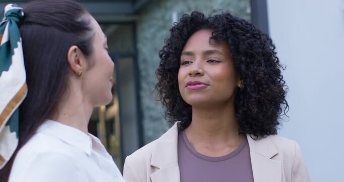 Diverse female team making eye contact by glass door, African American woman talking, saying hello