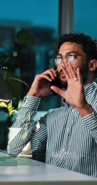 Businessman, night and phone call with discussion for proposal, negotiation or ideas at office desk. Man, employee or financial advisor talking in late evening for conversation or chat at workplace