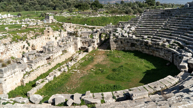 Ancient Roman theater ruins at Xanthos in Lycia, Mugla, Turkey. Stone semicircular seating tiers overlooking a mountain landscape