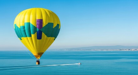 Fototapeta premium Vibrant hot air balloon soars above the tranquil blue sea.