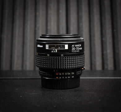 Gothenburg, Sweden - March 13 2026: Nikon AF Nikkor zoom lens on dark surface for vintage photography equipment concept.