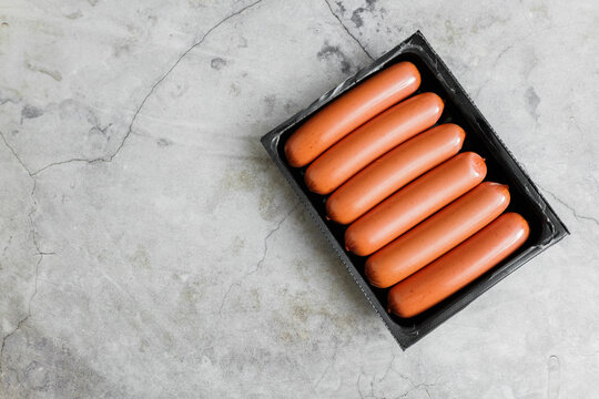 Delicious hot dogs ready for a summer barbecue on a rustic stone table