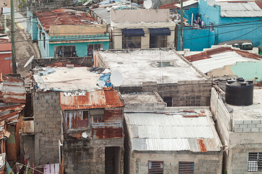 Rusty old roofs of a poor residential district of Santo Domingo, aerial urban view of Dominican Republic