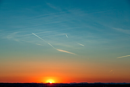 Kondensstreifen am Himmel bei Sonnenuntergang