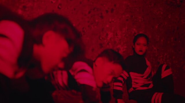 People in a Trance in a Sinister Red-Lit Room
