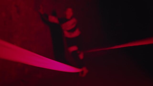 Woman Performing Theatrical Dance with Red Ribbons