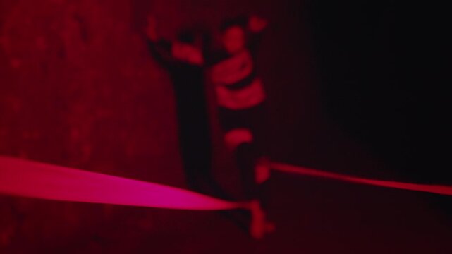 Woman in a Trance Performing a Ritual Dance in a Red Room
