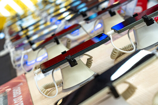 A Display of Modern Technology: Sleek Touchscreen Devices Showcasing Innovative Design and Features at a Retail Outlet