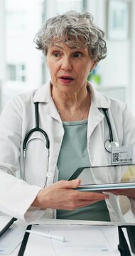 Hospital, tablet and mature doctor in office for consulting, appointment and report for diagnosis. Healthcare, clinic and woman on digital tech for medical service, assessment and patient review