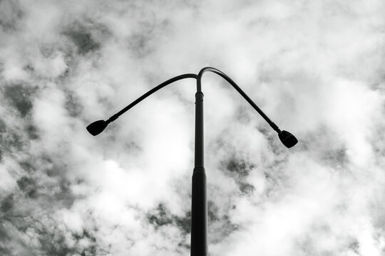 Black and white street lamp silhouette against dramatic cloudy sky. sity Prostejov, město Prostějov, Olomouck&yacute; kraj, Olomouc Region, ČR, Česko, Moravia, Czechia, Europe

