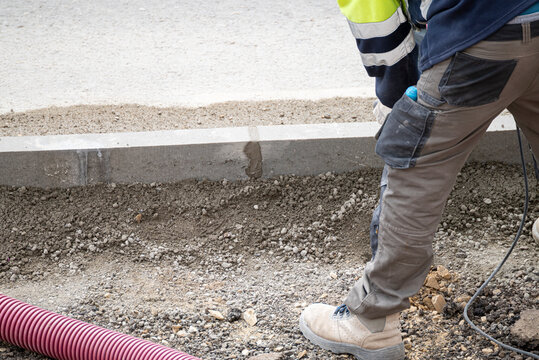Detailed view of a construction worker wearing safety gear on a building project