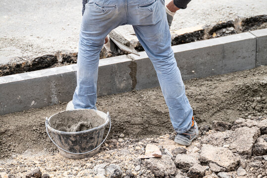 Building a sidewalk foundation with professional tools The Concept of hard work