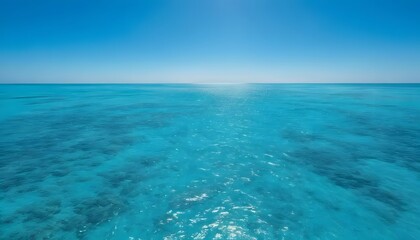 Obraz premium Serene turquoise ocean water under a clear blue sky