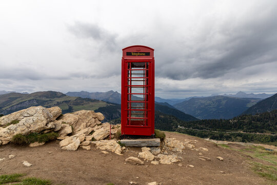 Iconic red British phone booth near the Roselend lake in the Beaufortain valley , Savoie, French alps