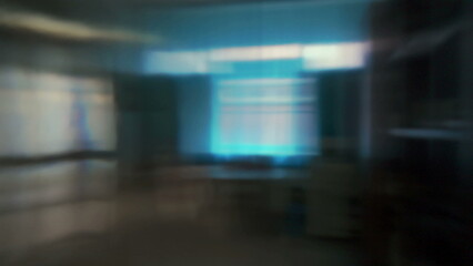 Blurred abstract view of room with window, desk, and bookshelves in motion or out of focus, creating impressionistic interior scene with soft light © Marco