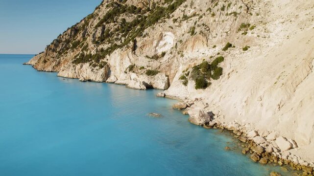 Coastal cliffs with white rock and blue sea waters in summer Cephalonia Greece